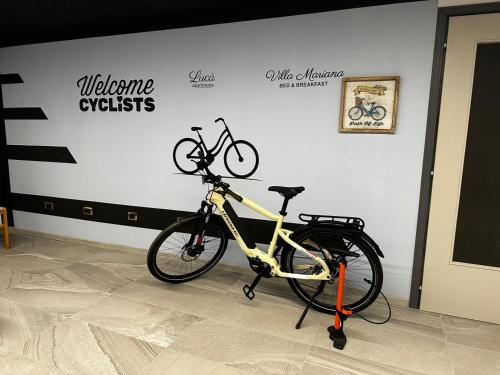a bike is parked on a stand in a room at Villa Mariana Bed and Breakfast in Saluzzo