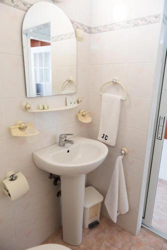 a white bathroom with a sink and a mirror at International Home of Scientists Joliot Curie in Saints Constantine and Helena