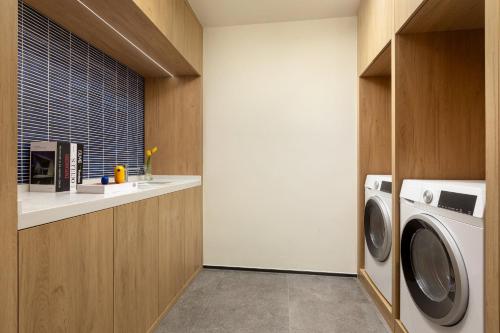 a laundry room with a washer and dryer at voco Xishuangbanna Gaozhuang by IHG in Jinghong