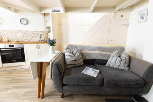 a living room with a couch and a table at The Bakehouse in Port Isaac