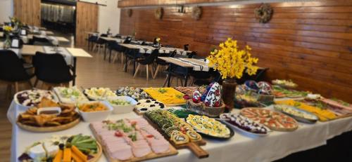 a table with many different types of food on it at WRZOS resort & wellness in Węgierska Górka
