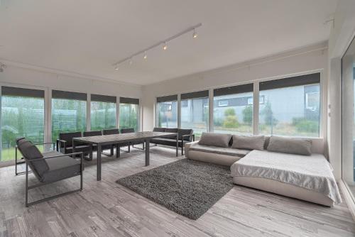 a living room with a couch and a table and chairs at Šaldorfská vila u vinařských sklepů - 8 osob in Nový Šaldorf