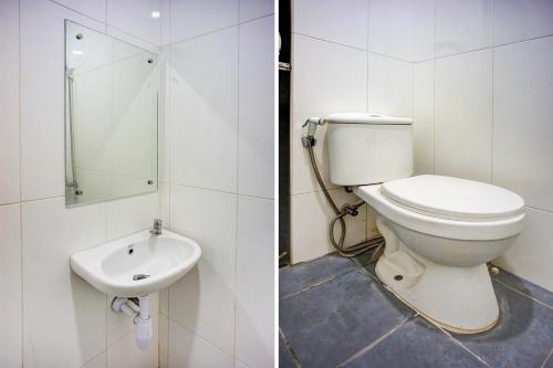 a bathroom with a toilet and a sink at Dancenter Helvetia Near Plaza Millenium Formerly Sunny Inn in Medan