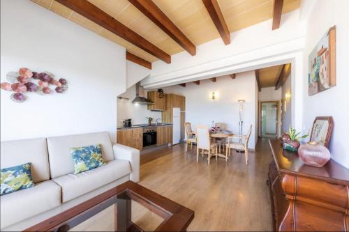 a living room with a couch and a table at Sa Figuereta Living Place in Ariany