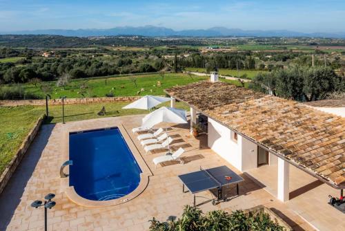 an external view of a villa with a swimming pool at Sa Figuereta Living Place in Ariany