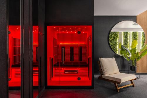 a red room with a chair and a mirror at Muse - LoftAffair Spa Collection in Kraków