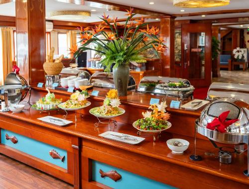 a buffet line with plates of food on it at Amanda Premier Cruise in Ha Long