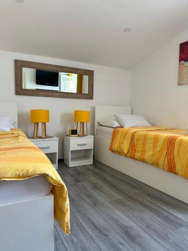 a bedroom with two beds and a mirror at Lora in Skradin