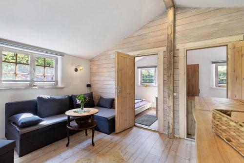a living room with a couch and a table at Blockhütte in Langewahl