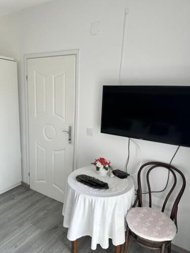 a room with a table and two chairs and a tv at Lora in Skradin