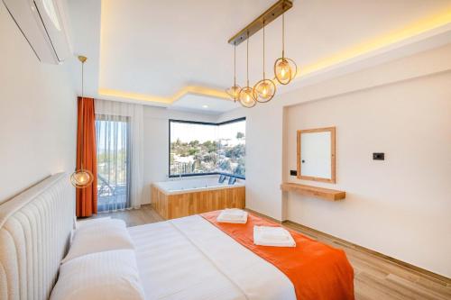 a bedroom with a large bed and a bath tub at Villa Zero in Fethiye