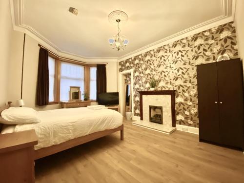 a bedroom with a bed and a fireplace at Inverness Holiday House in Dalneigh