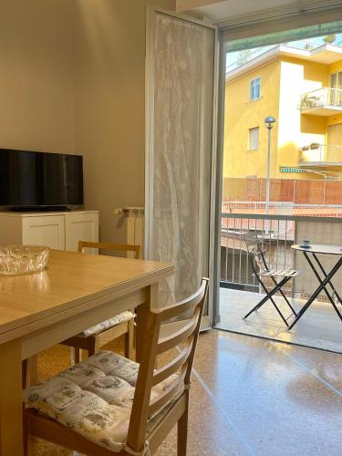 a dining room with a table and a large window at Mary's Home Cogoleto in Cogoleto