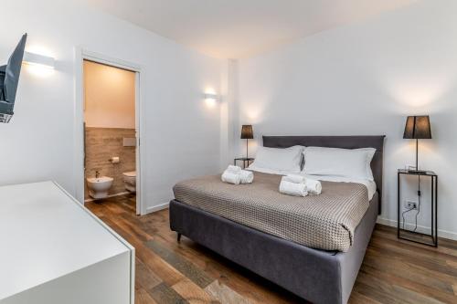 a bedroom with a bed with two towels on it at Santo Stefano Raro Rooms Collection in Brindisi