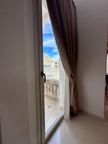 an open door to a window with a view at Casa Donna Concetta in Tricase