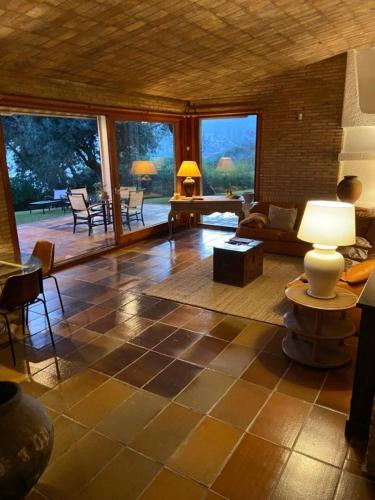 a living room with a couch and a table at Villa Juny Best view in North Barcelona Coast in Cabrils