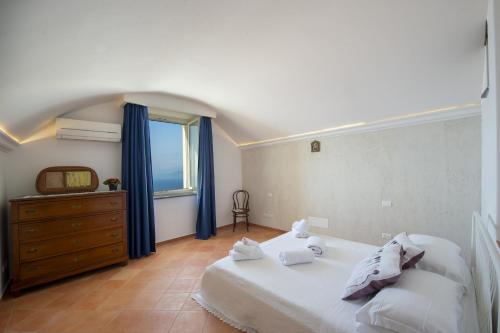 a bedroom with a large bed and a window at Villa Cimino - for walking lovers! in Praiano