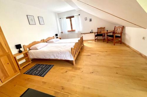 a bedroom with a bed and a table in it at Kaczmarówka in Mchawa