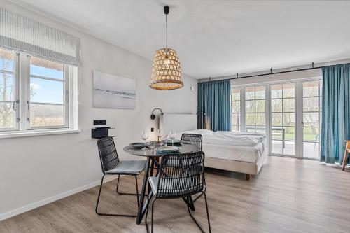 a bedroom with a table and chairs and a bed at Beach Lodge Beach Lodge Appartement 2 in Böhl
