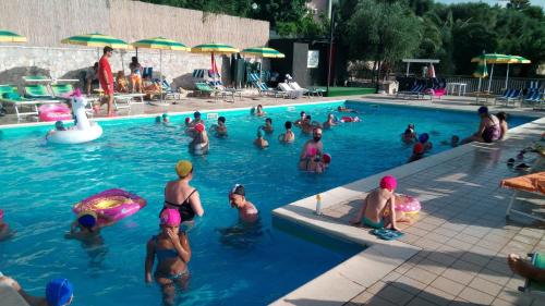 a group of people swimming in a swimming pool at Ibisco Hotel in Rodi Garganico