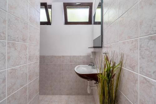 a bathroom with a sink and a mirror at Luxury Seaview Apartment in Juraši