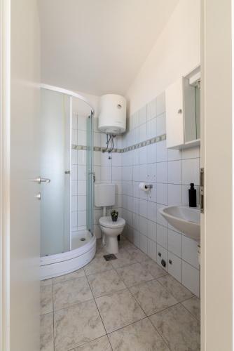 a bathroom with a toilet and a sink at Villa Valamare in Podstrana