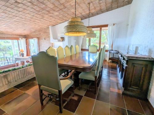 a dining room with a wooden table and chairs at Villa Juny Best view in North Barcelona Coast in Cabrils