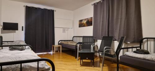 a room with a bunch of beds and chairs at Apartmenthaus MITTERFELD in Mitterfeld