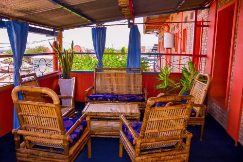 two chairs and a table on a balcony at Maison d'Accueil - Fondation San Filippo Neri in Bujumbura