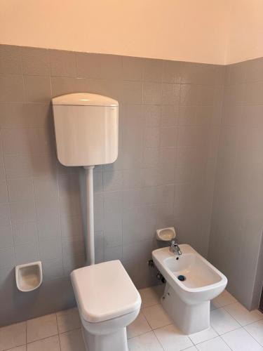 a small bathroom with a toilet and a sink at Casa Aris in Monfalcone