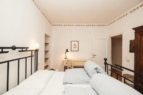 a bedroom with a bed and a book shelf at Giardino Segreto in Cetona