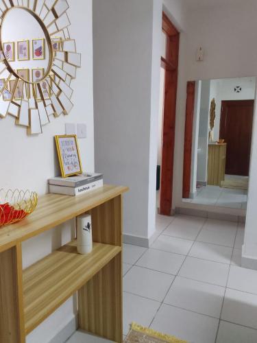 a room with a table and a mirror on the wall at Tabbys staycation in Mombasa