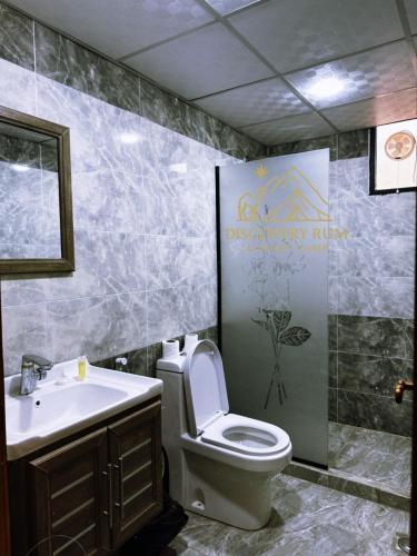 a bathroom with a toilet and a sink at Ayla Rum Luxury Camp in Wadi Rum