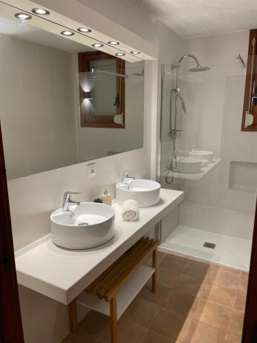 a bathroom with two sinks and a mirror at Villa Juny Best view in North Barcelona Coast in Cabrils