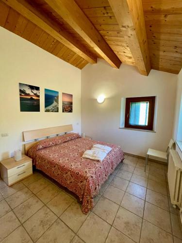 a bedroom with a bed and a wooden ceiling at Agriturismo Conero in Ancona