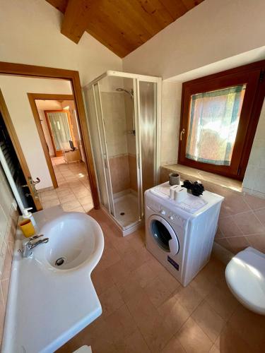 a bathroom with a sink and a washing machine at Agriturismo Conero in Ancona