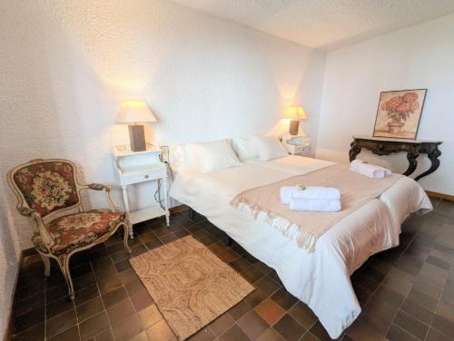 a bedroom with a large bed and a chair at Villa Juny Best view in North Barcelona Coast in Cabrils