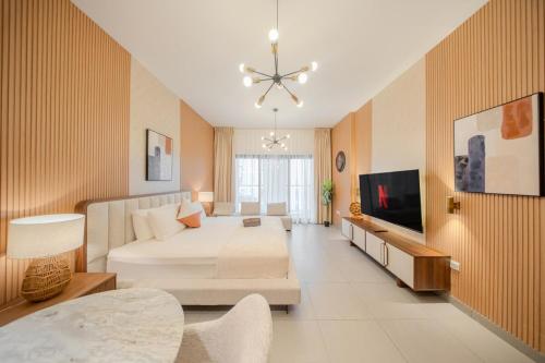 a large living room with a bed and a tv at City Central Luxury Apartment With Balcony by Bluecloud Holidays in Sharjah