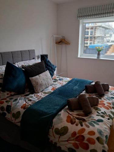 a bed with a blanket and pillows on it at Fistral beach apartment in Newquay
