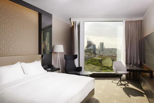 a hotel room with a bed and a large window at Hilton Tallinn Park in Tallinn