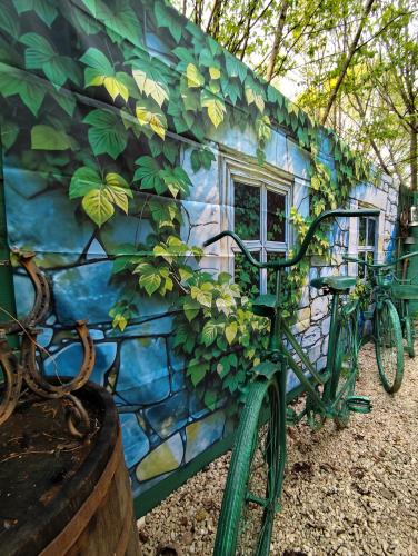 a bike parked in front of a building with a mural at Brvnara Fairy Tale in Cetinje