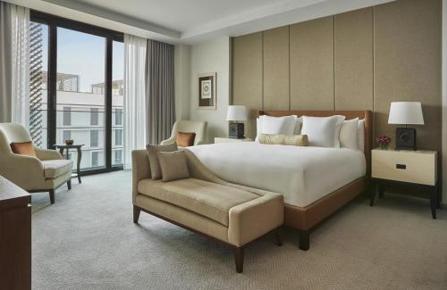 a large bedroom with a large bed and a chair at Four Seasons Hotel Casablanca in Casablanca
