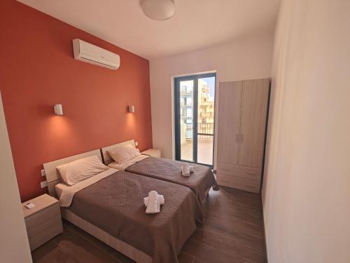 a bedroom with a bed with a teddy bear on it at New Marsalforn Serenity Stay & Near Sea Apartment in Marsalforn