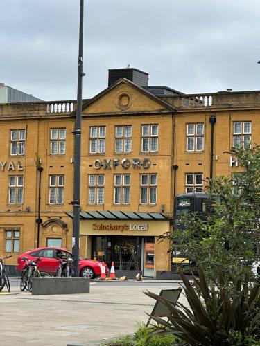 a building with a red car parked in front of it at Parkend Room Stays in Oxford