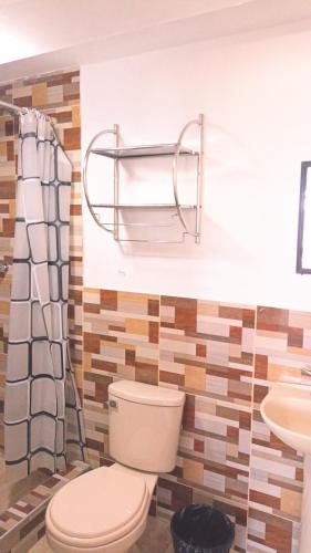 a bathroom with a toilet and a sink at Good VIEW HOME in Puno
