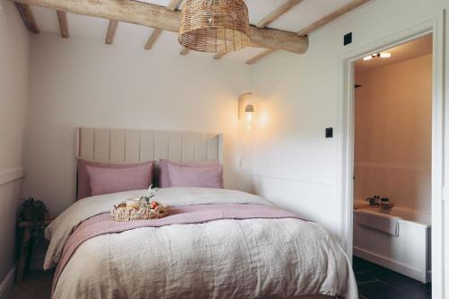 a bedroom with a bed with a basket on it at North Lakes - The Fold Holiday Cottage in Penrith