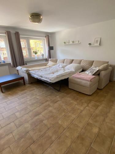 a living room with a couch and a table at Ferienwohnung Familie Reiprich in Bremerhaven