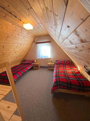 a attic room with two bunk beds in it at Horská Chata Martin in Loučná pod Klínovcem