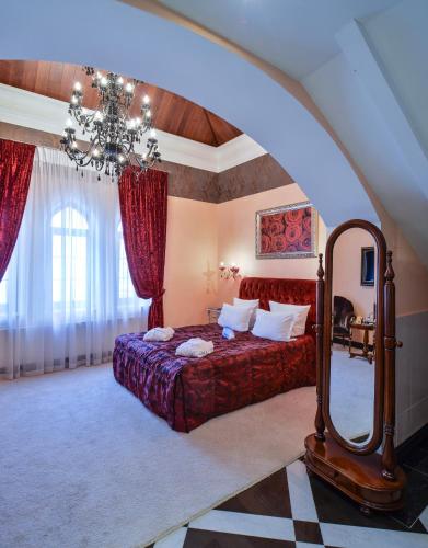 a bedroom with a bed and a large mirror at La Gioconda Boutique Hotel in Odesa