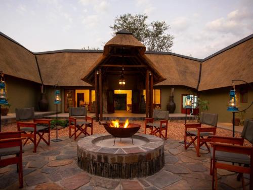 a fire pit in the middle of a patio at Etnika Manor House in Hoedspruit